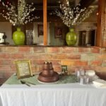 Three-tier chocolate wedding cake displayed on the dessert table