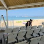 Ceremony seating rows at a beach pavilion with reserved seating sign