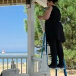 Hanging ceremony drapery under a beachside pavilion roof