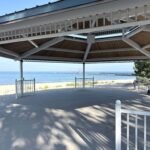View of the beach pavilion ceremony space overlooking the pier and lighthouse