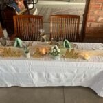 Sweetheart table decorated with gold Mr and Mrs signs and floral accents